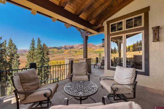 a view of a patio with couches table and chairs and potted plants