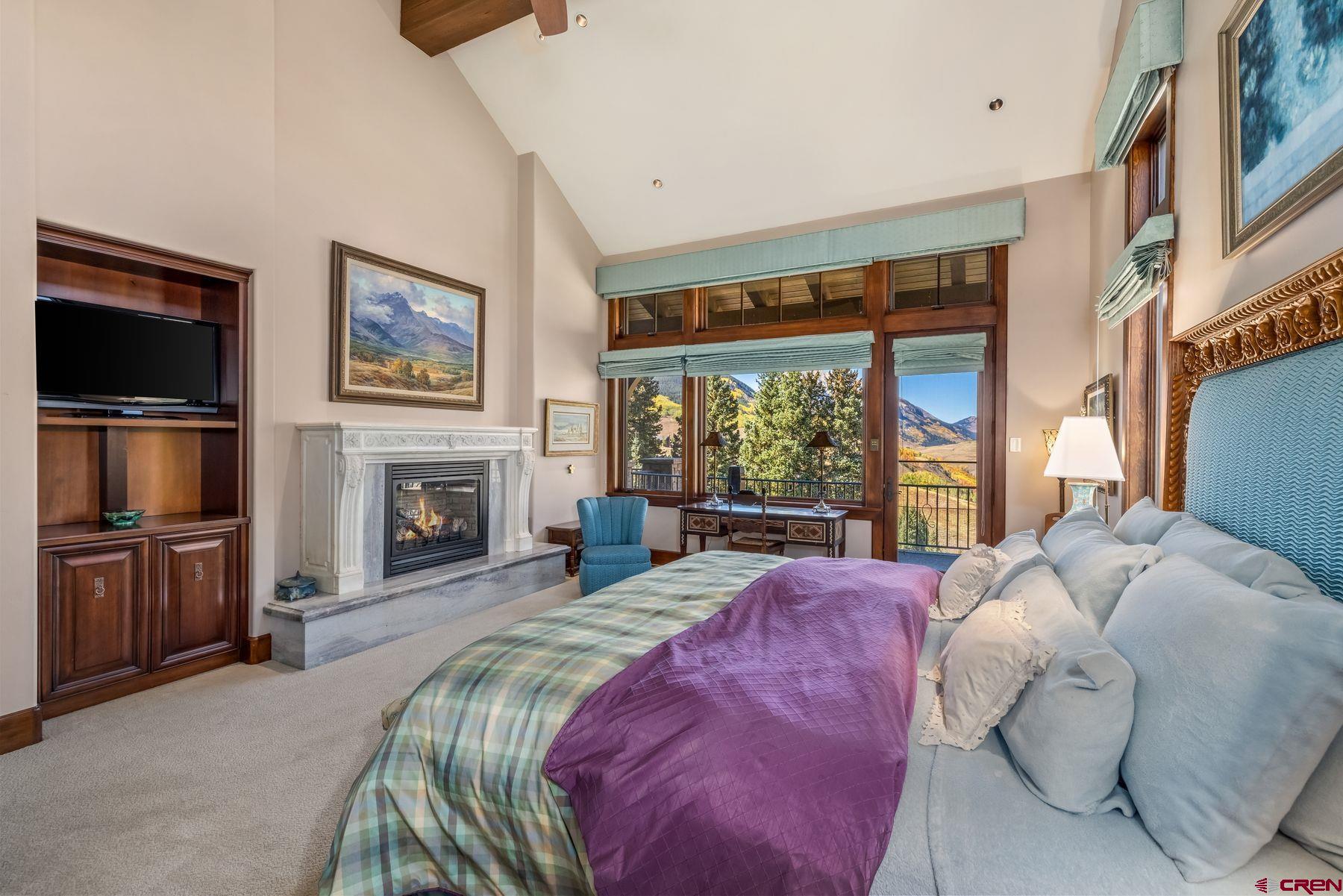 28 Kokanee Lane Crested Butte, CO 81225 - Photo 25 of 45 a bed sitting in a bedroom next to a window with a flat screen tv
