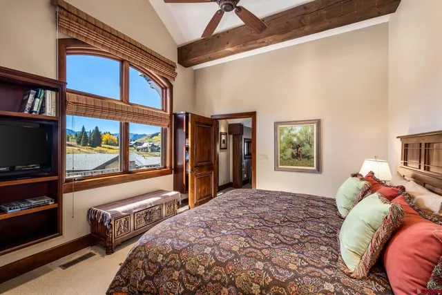 a bathroom with a granite countertop sink and a large mirror