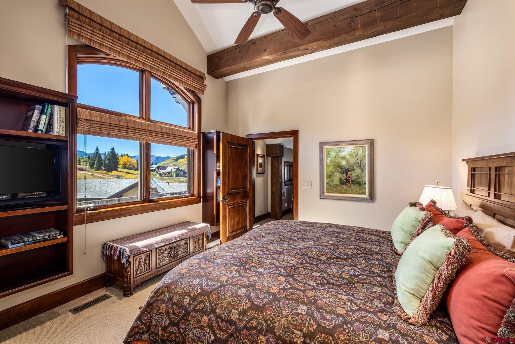 28 Kokanee Lane Crested Butte, CO 81225 - Photo 28 of 45 a bedroom with a bed and a flat screen tv