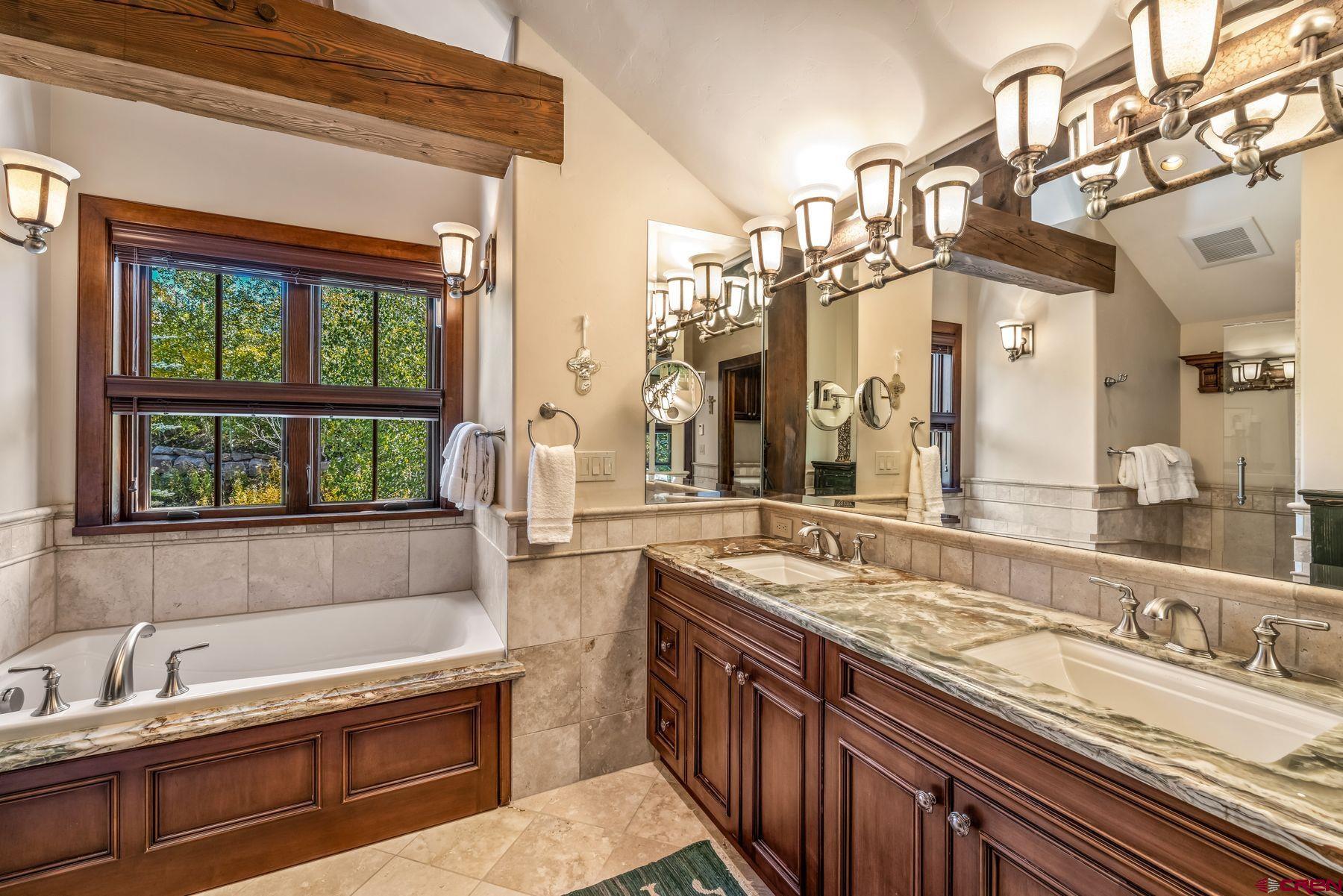28 Kokanee Lane Crested Butte, CO 81225 - Photo 29 of 45 a bathroom with a granite countertop sink and a large mirror