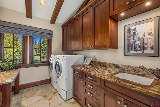 a living room with furniture tv and a large window