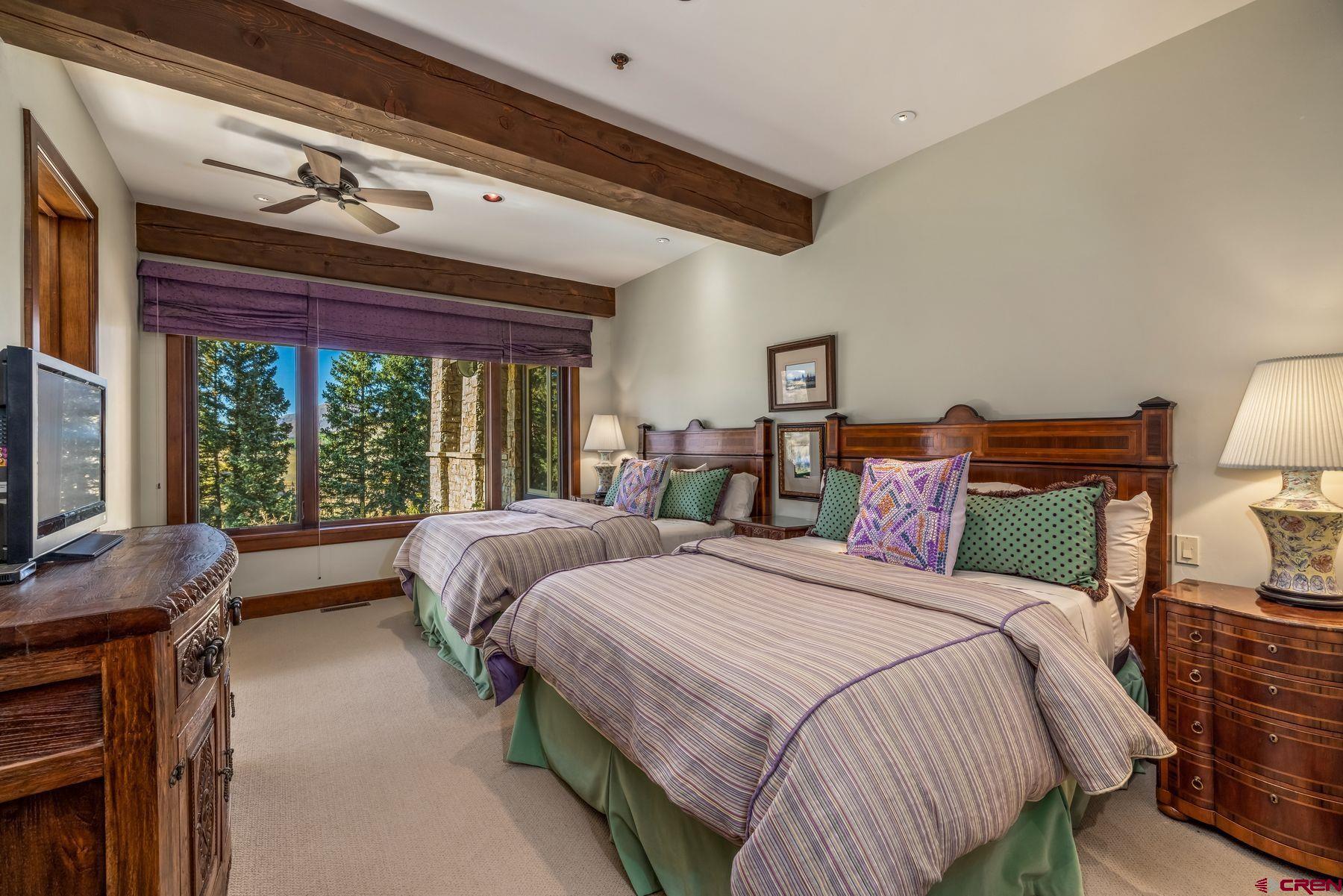 28 Kokanee Lane Crested Butte, CO 81225 - Photo 39 of 45 a spacious bedroom with two beds and a large window