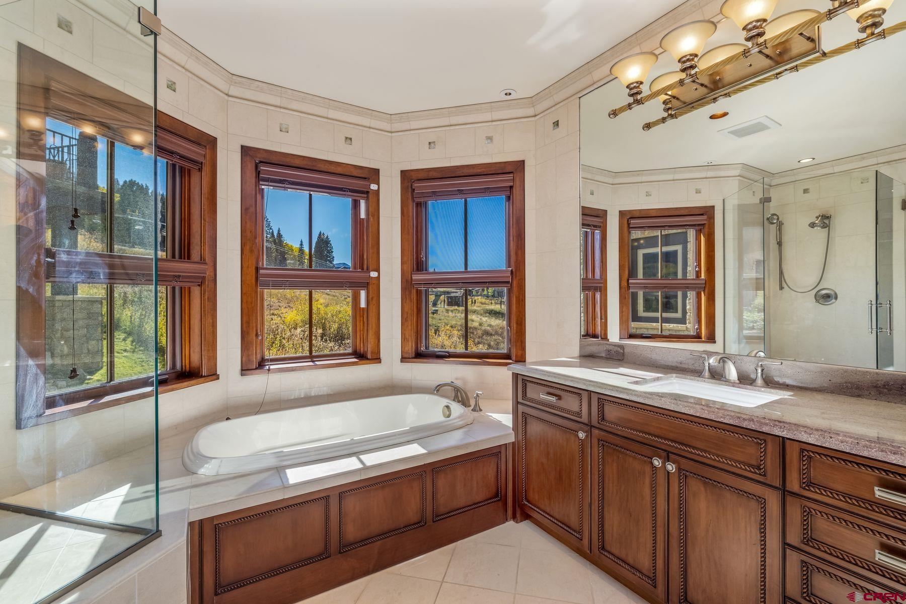28 Kokanee Lane Crested Butte, CO 81225 - Photo 40 of 45 a spacious bathroom with a granite countertop tub sink and large window
