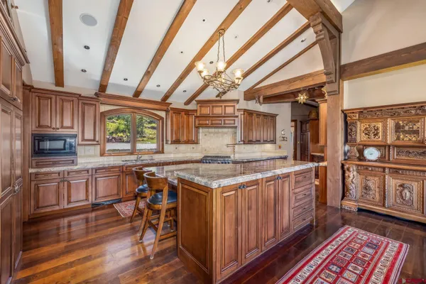 a kitchen with stainless steel appliances granite countertop a stove and a wooden cabinets