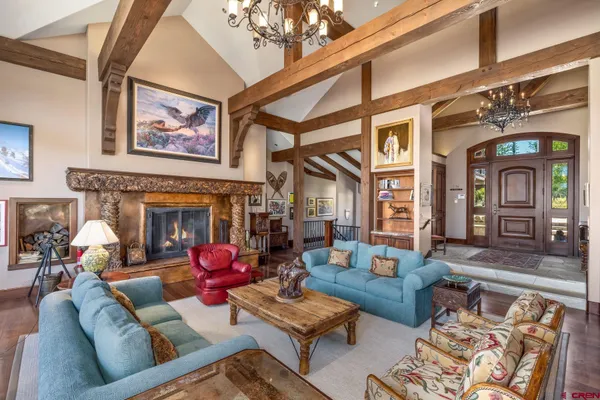 a living room with furniture fireplace and a window