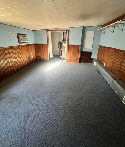 a view of an empty room with window and a couch