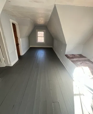 a view of wooden floor and windows in a room