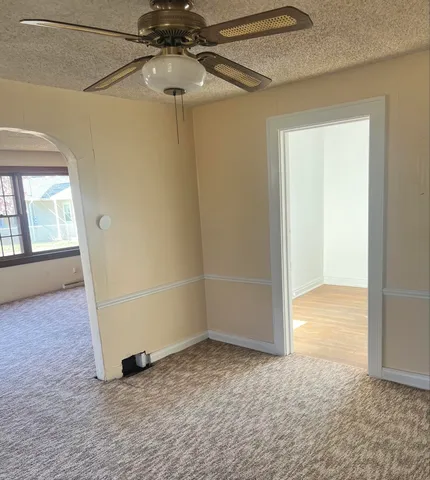 an empty room with a empty space and windows