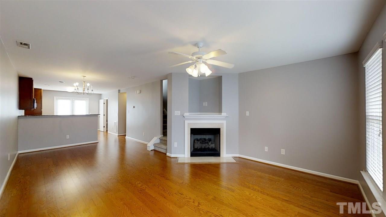2133 Kedvale Avenue Raleigh, NC 27617 - Photo 11 of 25 a view of an empty room with a fireplace and a window