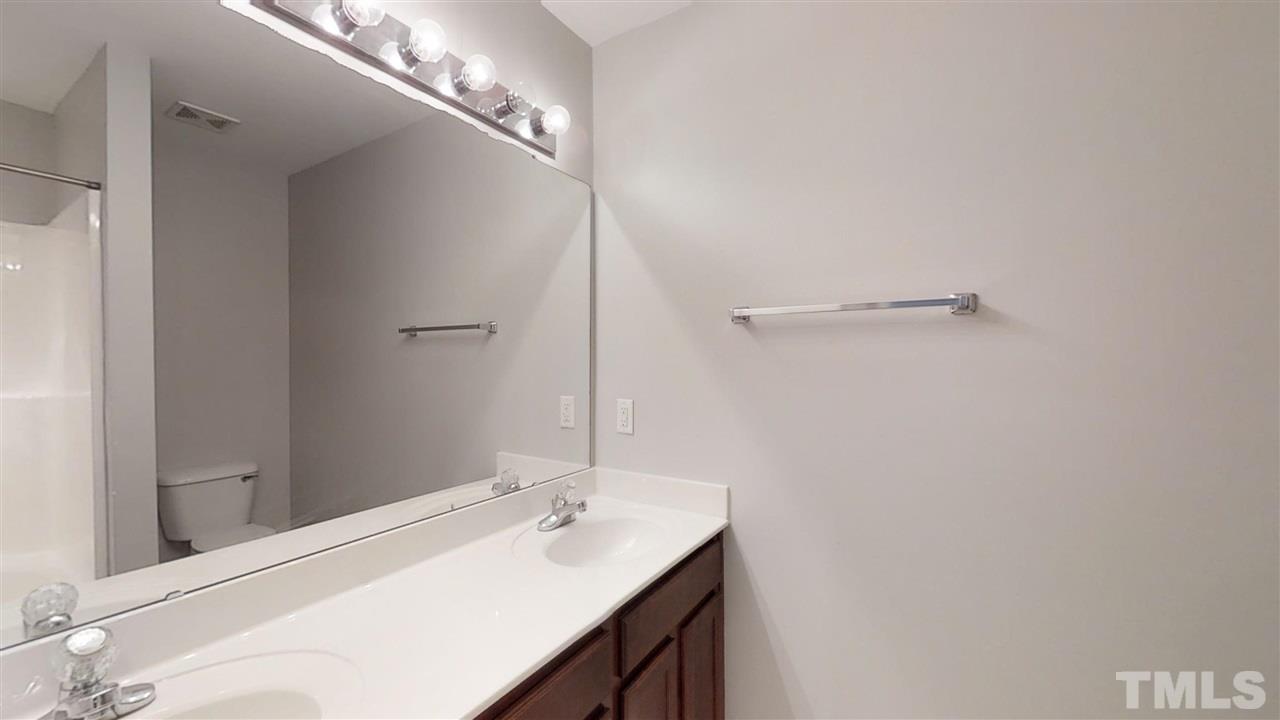 2133 Kedvale Avenue Raleigh, NC 27617 - Photo 15 of 25 a bathroom with a sink and a mirror