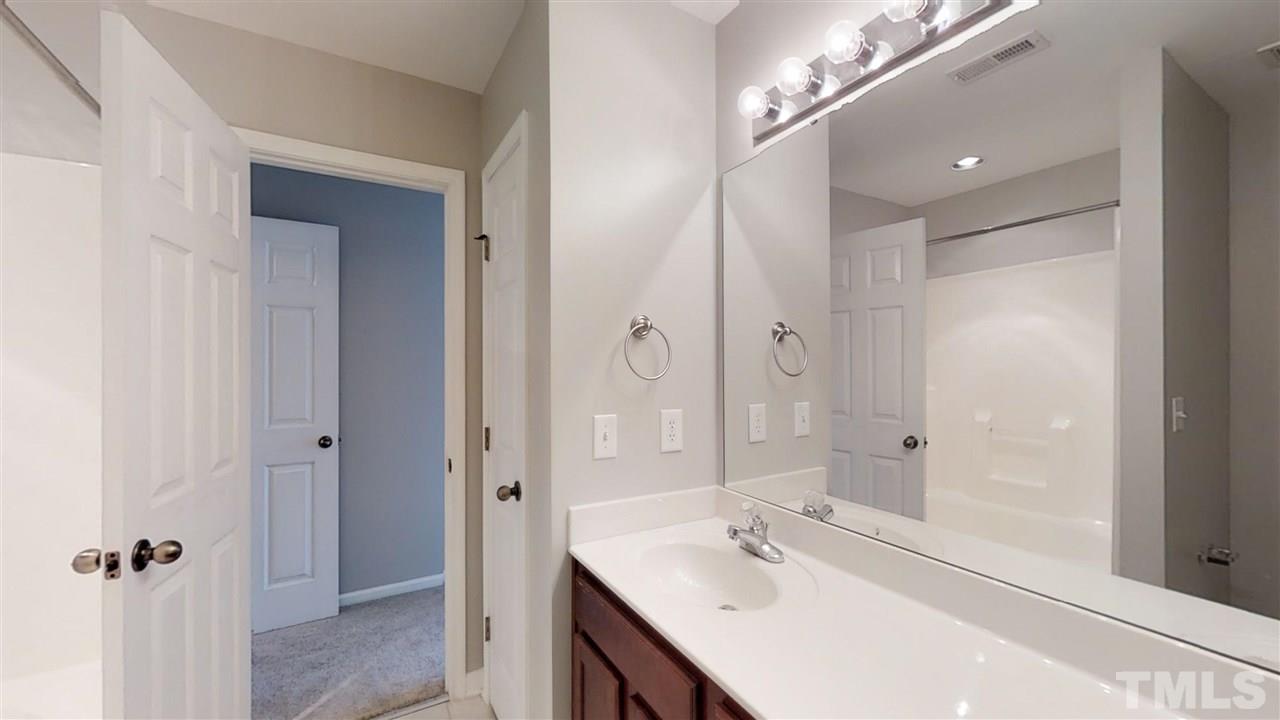 2133 Kedvale Avenue Raleigh, NC 27617 - Photo 16 of 25 a bathroom with a bathtub shower sink vanity granite and shower
