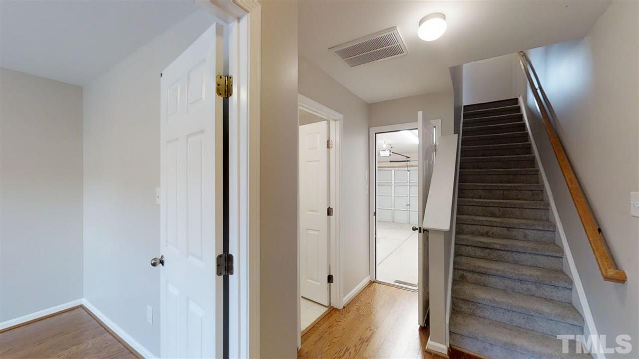 2133 Kedvale Avenue Raleigh, NC 27617 - Photo 3 of 25 a view of a hallway with wooden floor and staircase