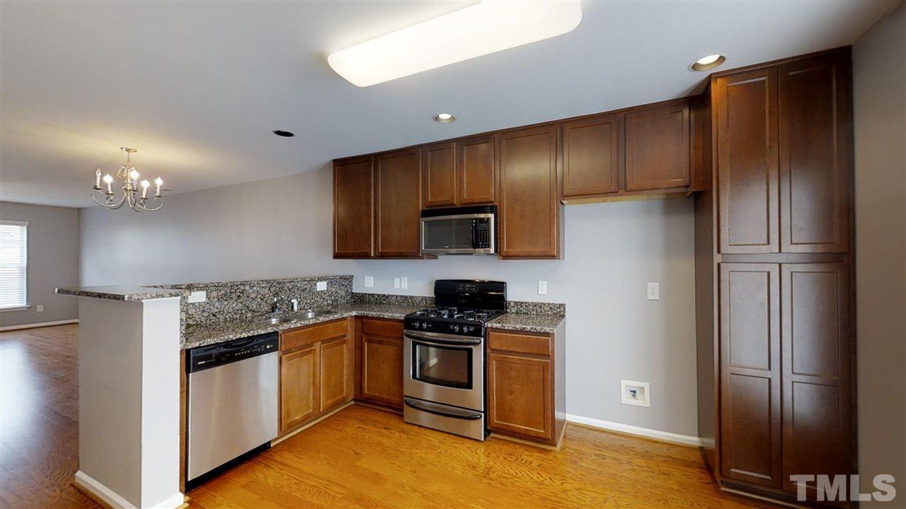 2133 Kedvale Avenue Raleigh, NC 27617 - Photo 8 of 25 a kitchen with stainless steel appliances granite countertop a refrigerator stove and oven