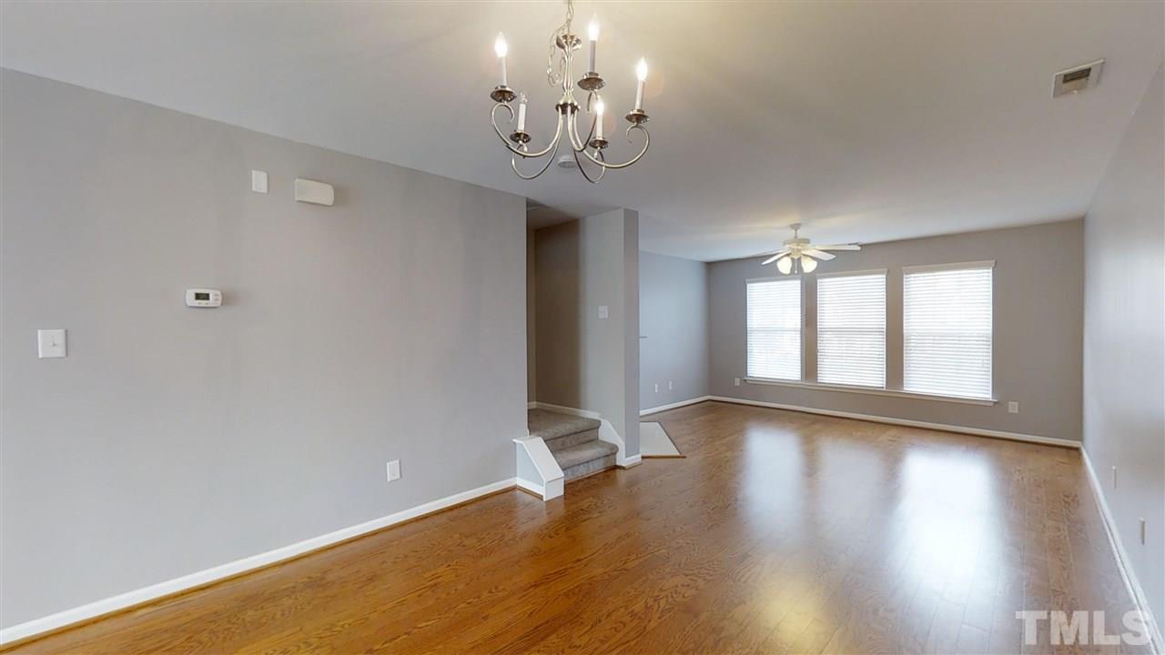2133 Kedvale Avenue Raleigh, NC 27617 - Photo 25 of 25 a view of an empty room with wooden floor and a window