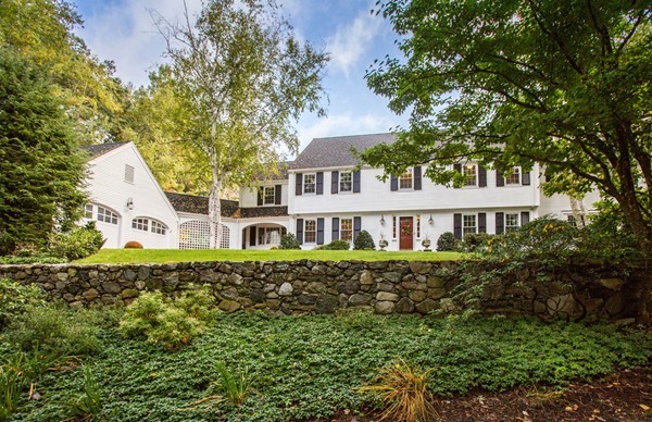 a view of a house with a yard and potted plants