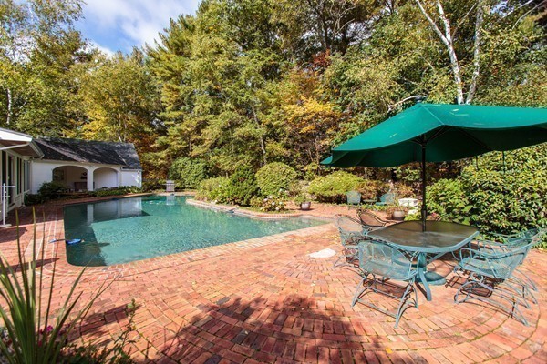 89 Black Oak Road Weston, MA 02493 - Photo 12 of 14 a view of a backyard with furniture and a garden