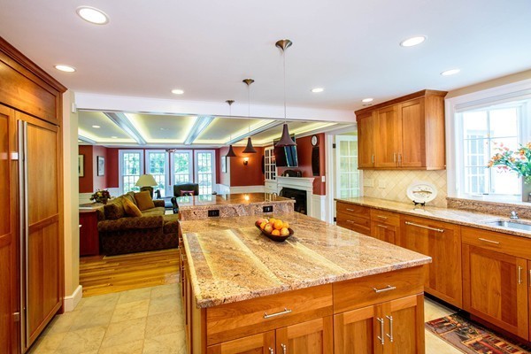 89 Black Oak Road Weston, MA 02493 - Photo 2 of 14 a kitchen with stainless steel appliances kitchen island granite countertop a refrigerator a sink dishwasher a dining table and chairs with wooden floor