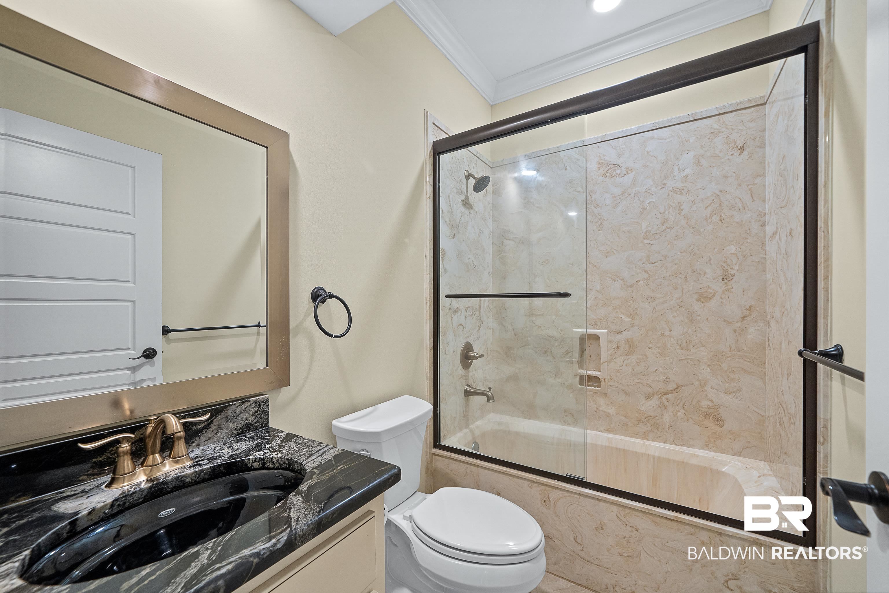 356 Liberty Street Fairhope, AL 36532 - Photo 23 of 39 Bathroom with vanity, ornamental molding, and enclosed tub / shower combo