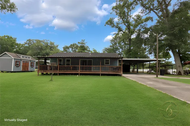 a view of a house with a backyard