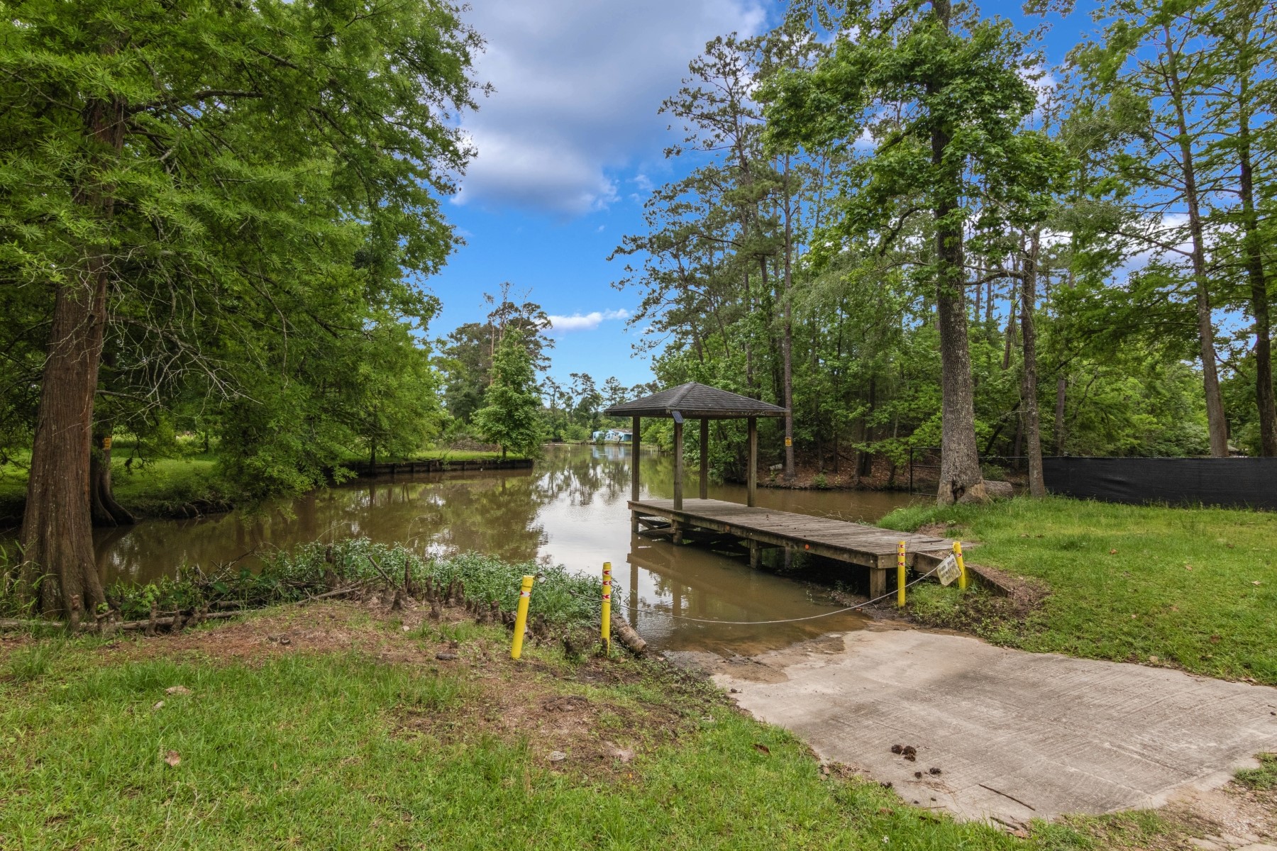 134 Magnolia Point Drive Houston, TX 77336 - Photo 30 of 31 a view of a lake with a bench and trees