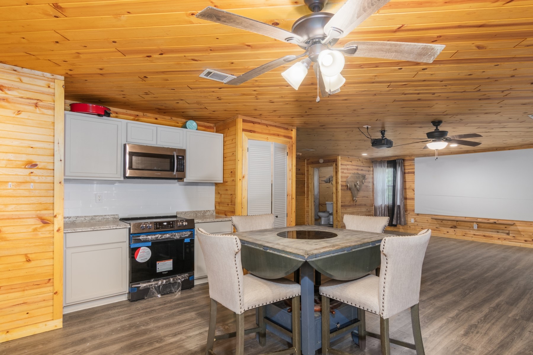 134 Magnolia Point Drive Houston, TX 77336 - Photo 10 of 31 a kitchen with stainless steel appliances kitchen island granite countertop a table chairs in it and wooden floors