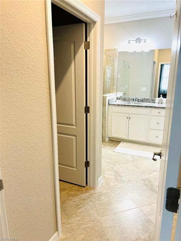 1599 Marton Court Naples, FL 34113 - Photo 11 of 22 a bathroom with a granite countertop sink and a mirror
