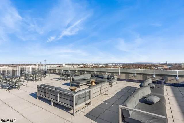 a view of a terrace with lawn chairs