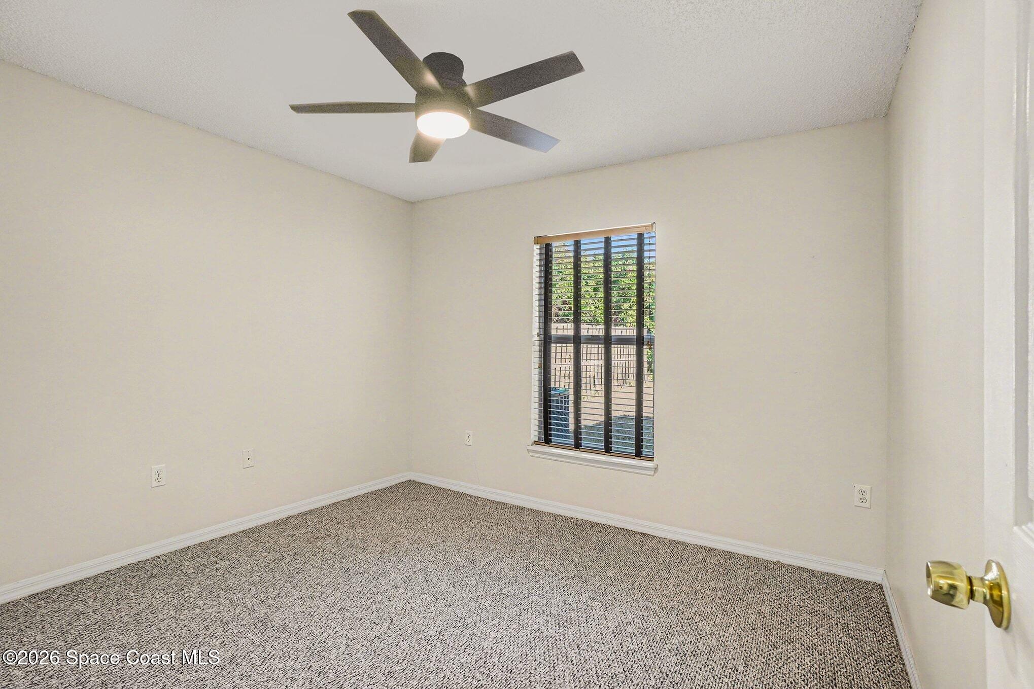 2268 Spring Creek Circle Palm Bay, FL 32905 - Photo 12 of 23 an empty room with a window