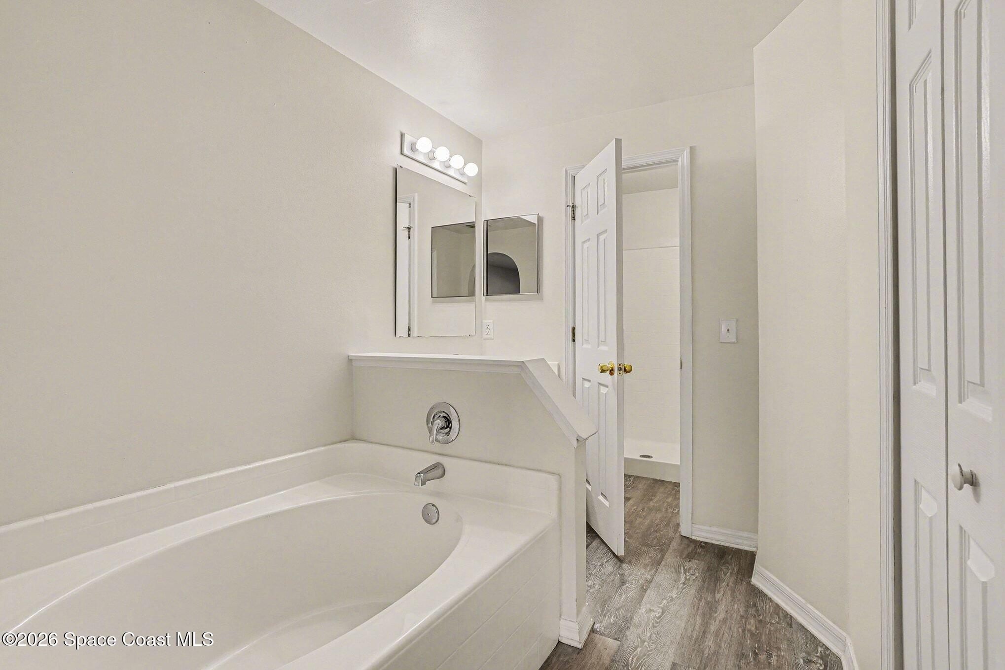 2268 Spring Creek Circle Palm Bay, FL 32905 - Photo 16 of 23 a bathroom with a bathtub a toilet and a shower