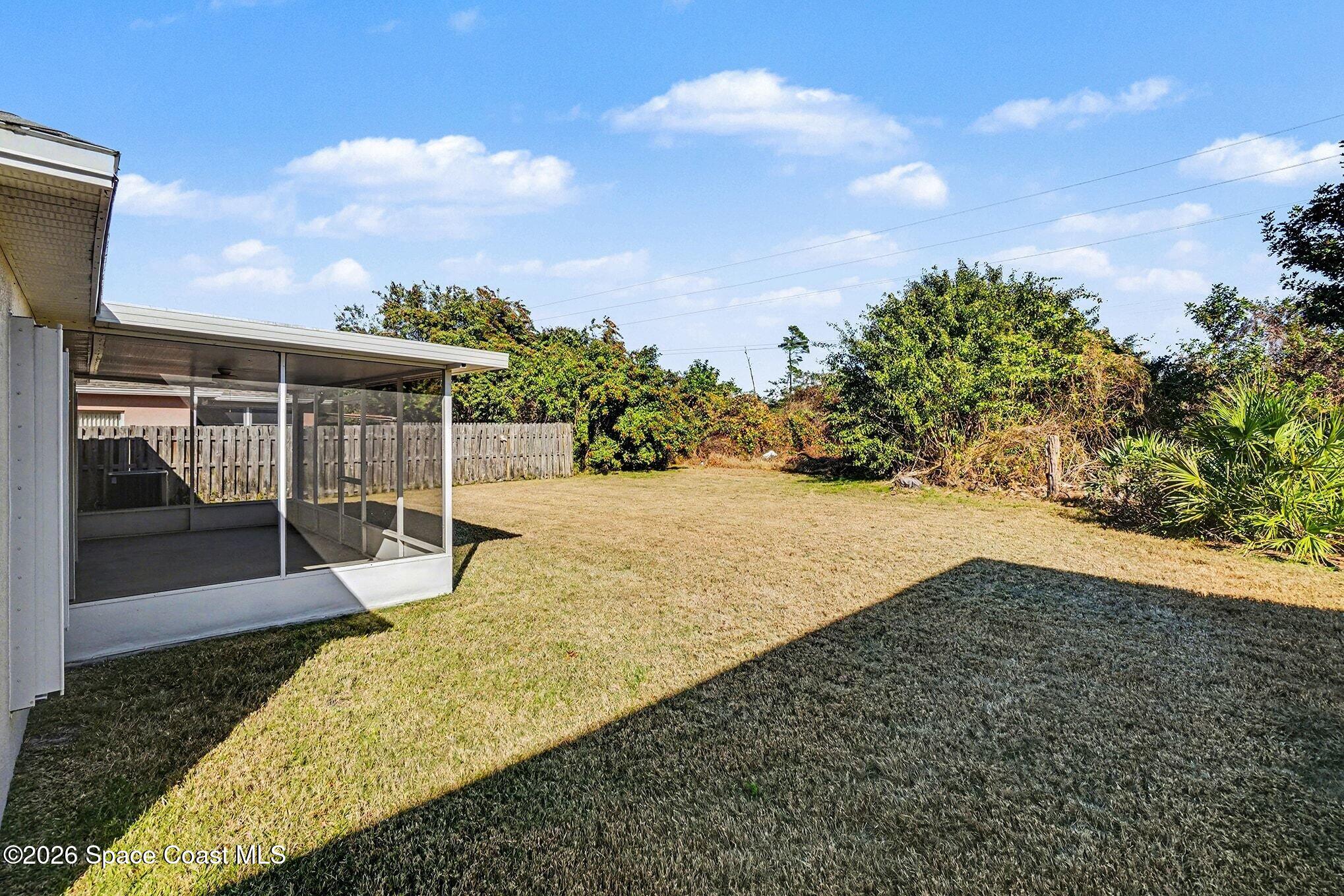 2268 Spring Creek Circle Palm Bay, FL 32905 - Photo 19 of 23 a view of a backyard