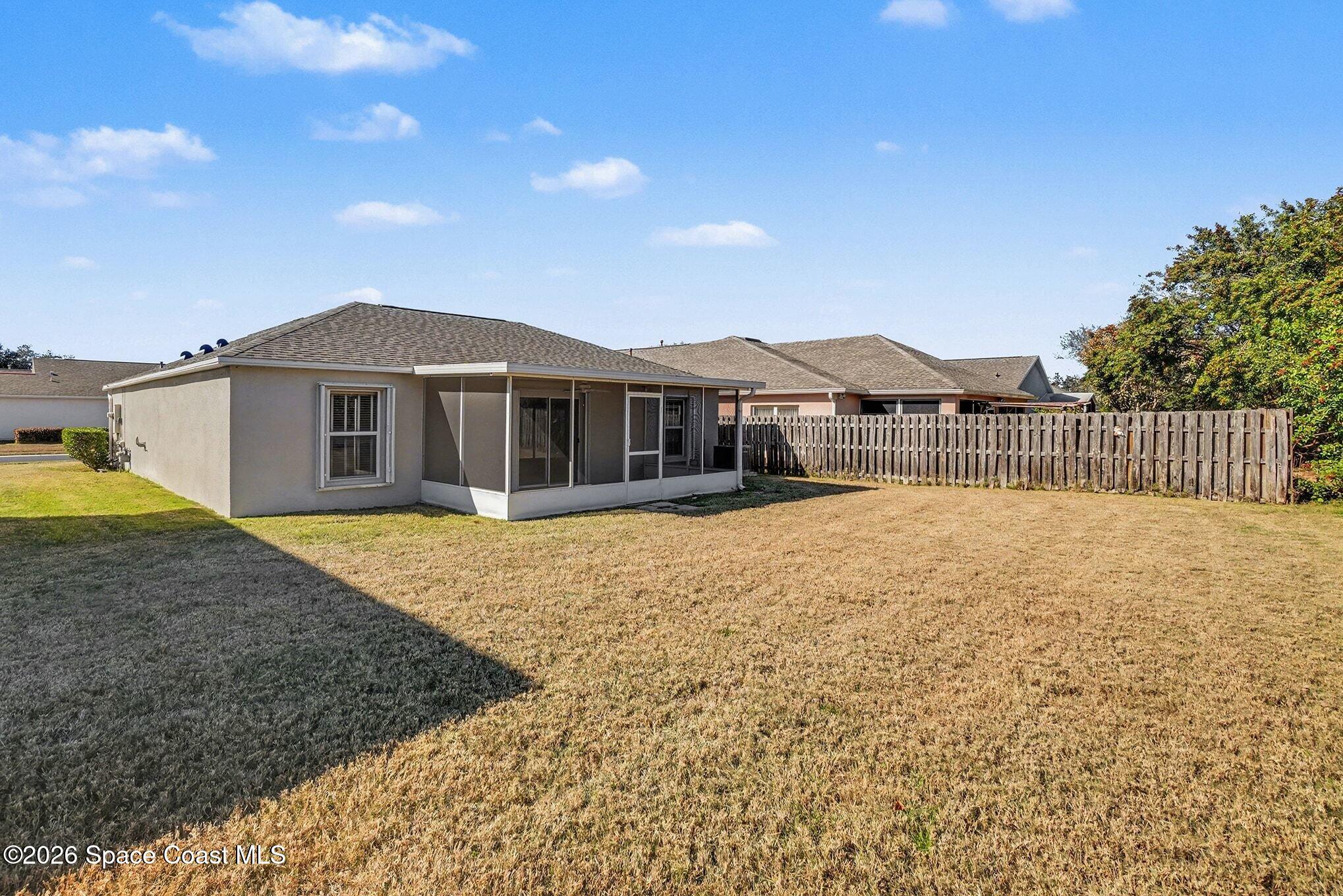 2268 Spring Creek Circle Palm Bay, FL 32905 - Photo 20 of 23 a front view of a house with a garden