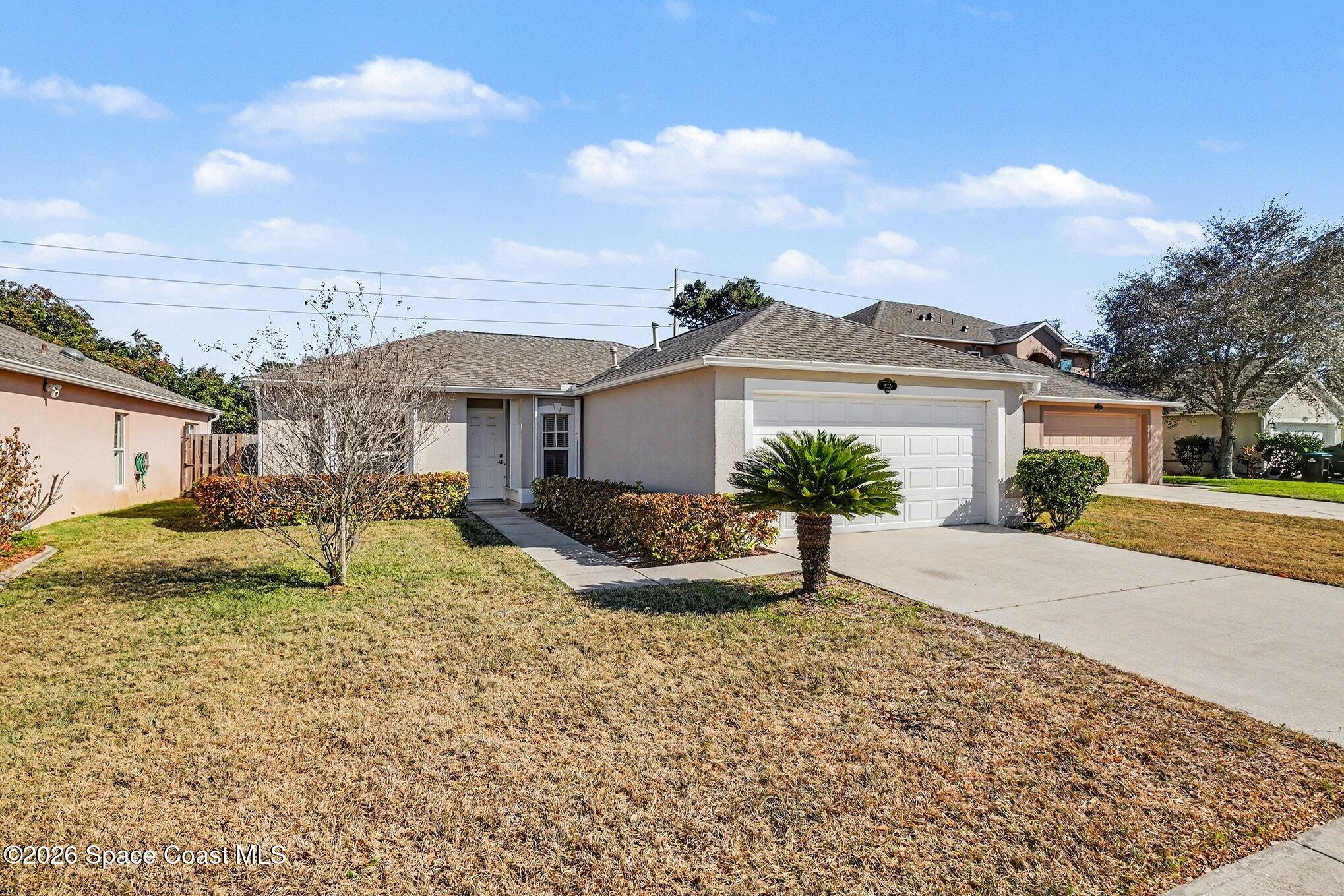 2268 Spring Creek Circle Palm Bay, FL 32905 - Photo 2 of 23 a view of a house with a yard and sitting area