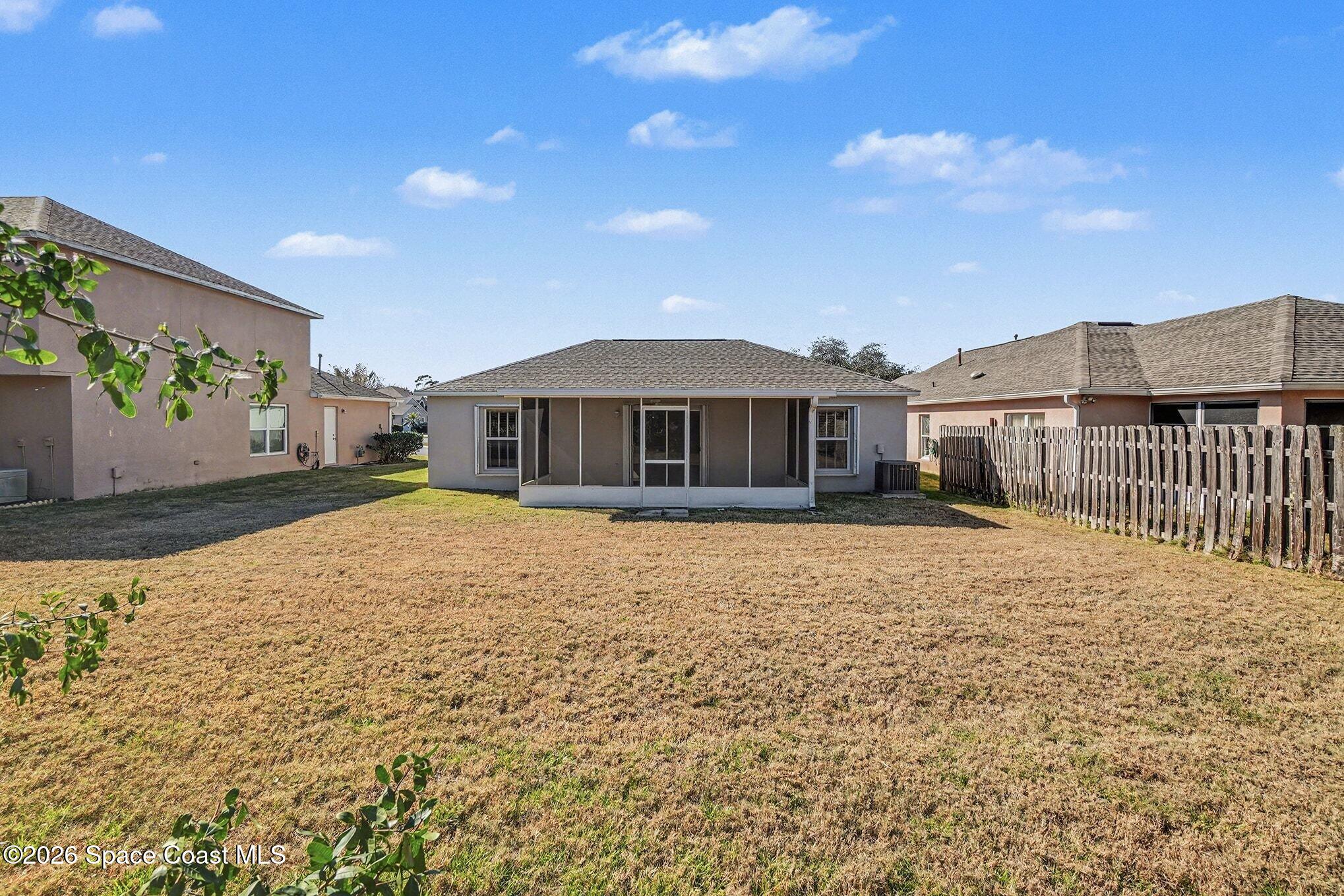 2268 Spring Creek Circle Palm Bay, FL 32905 - Photo 21 of 23 a house with yard in front of it