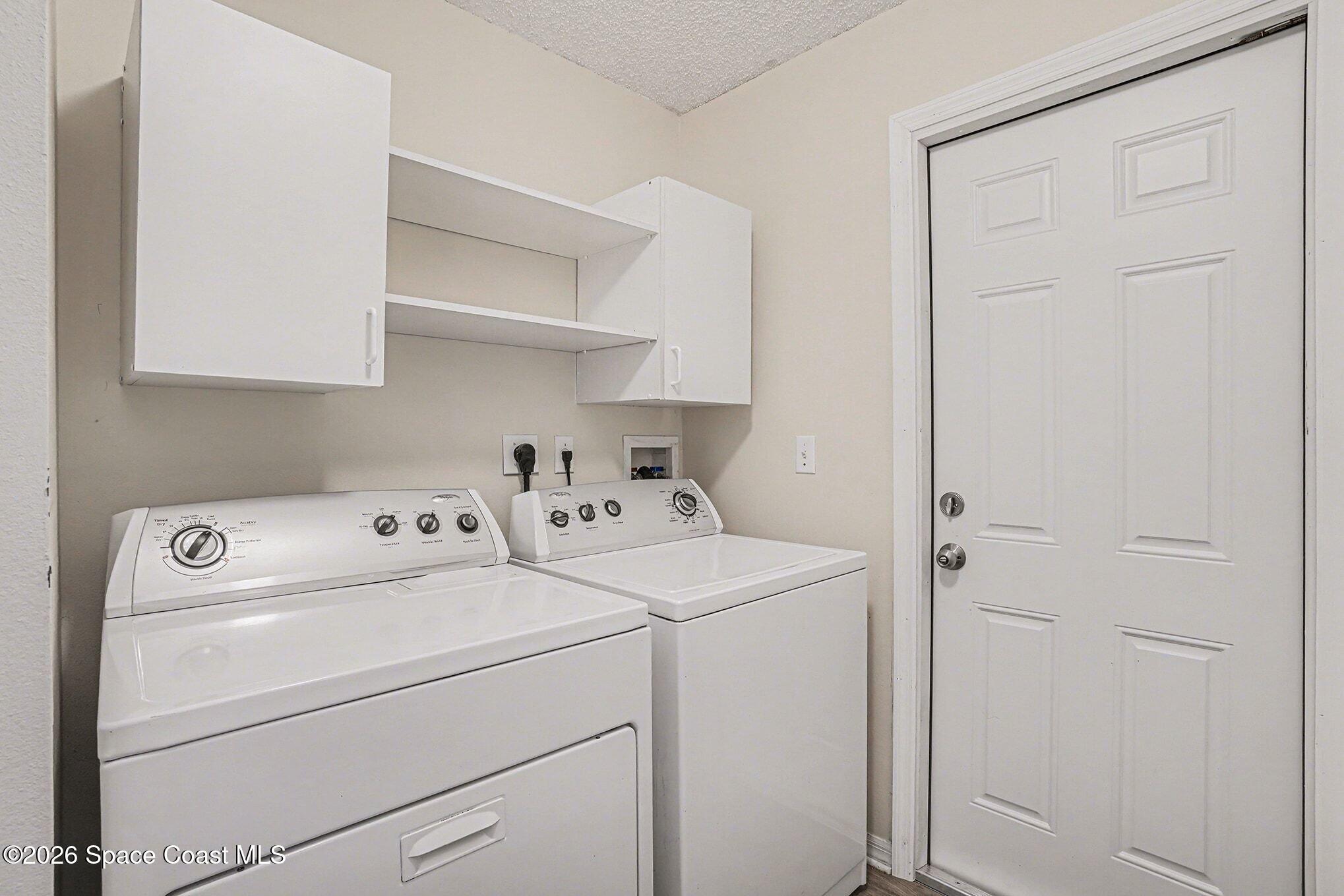 2268 Spring Creek Circle Palm Bay, FL 32905 - Photo 7 of 23 a view of storage and utility room with washer and dryer