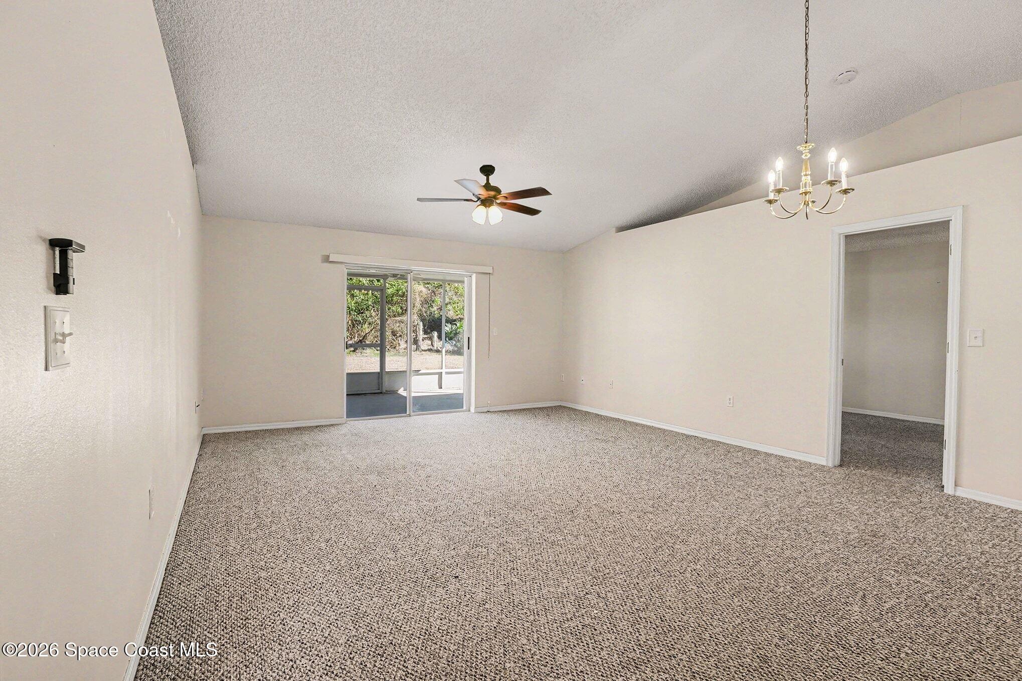 2268 Spring Creek Circle Palm Bay, FL 32905 - Photo 8 of 23 an empty room with windows and ceiling fan