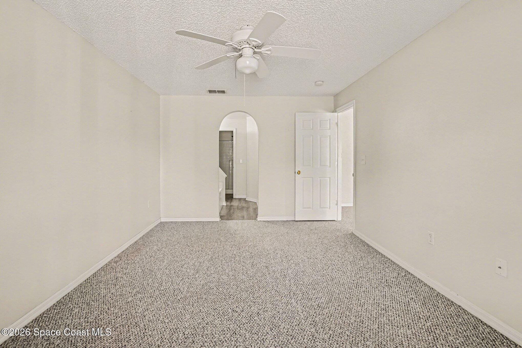 2268 Spring Creek Circle Palm Bay, FL 32905 - Photo 9 of 23 an empty room with a ceiling fan and a window