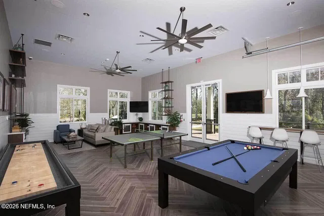 a living room with furniture a flat screen tv and a large window