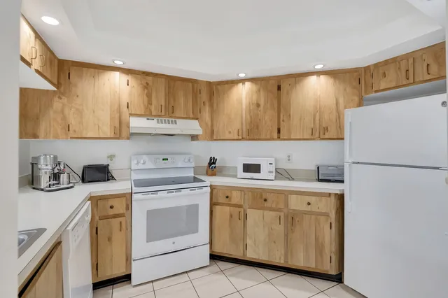a kitchen with a sink a stove a refrigerator and cabinets