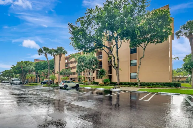 a row of palm trees in front of a house