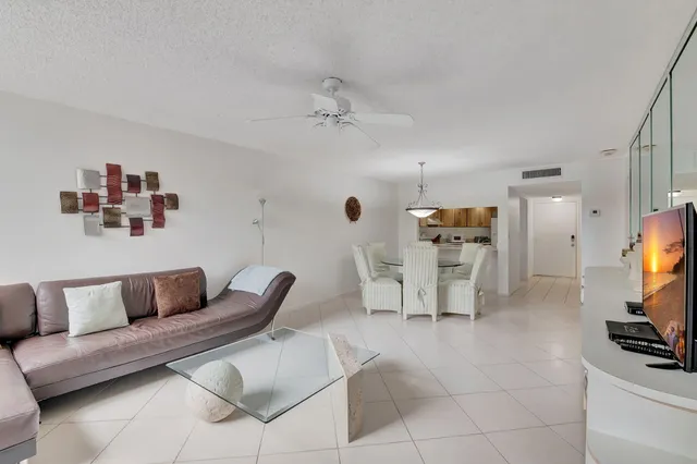 a living room with furniture a flat screen tv and a couch