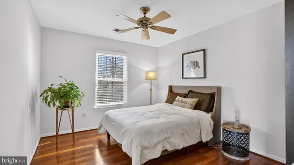 a bedroom with a bed and ceiling fan