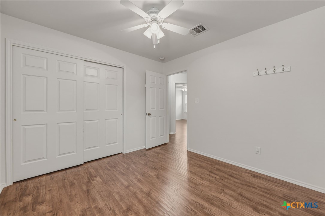 109 Comal Cove Elgin, TX 78621 - Photo 17 of 34 a view of an empty room with closet and a chandelier fan