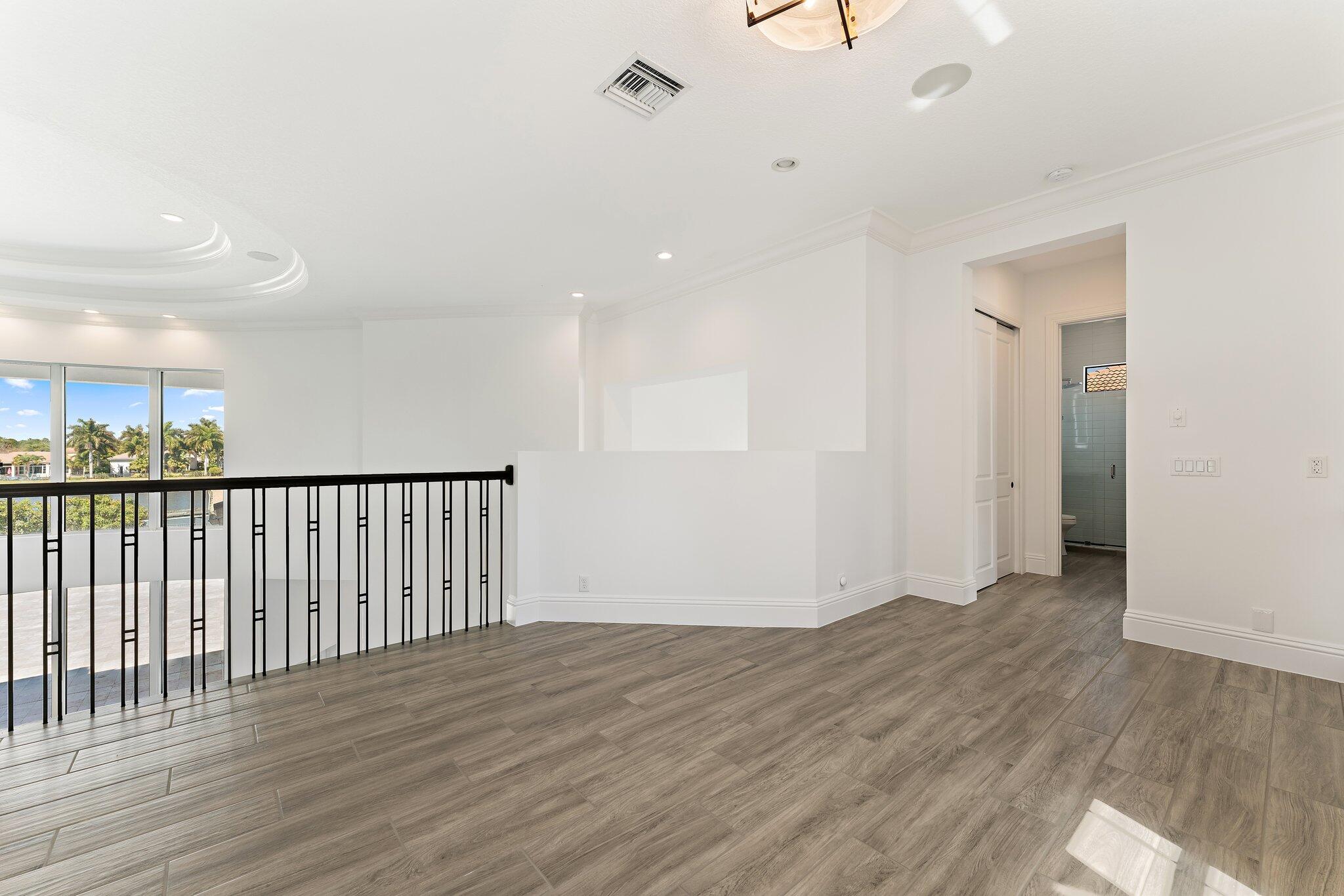 187 Elena Court Jupiter, FL 33478 - Photo 77 of 105 a view of a hallway with wooden floor