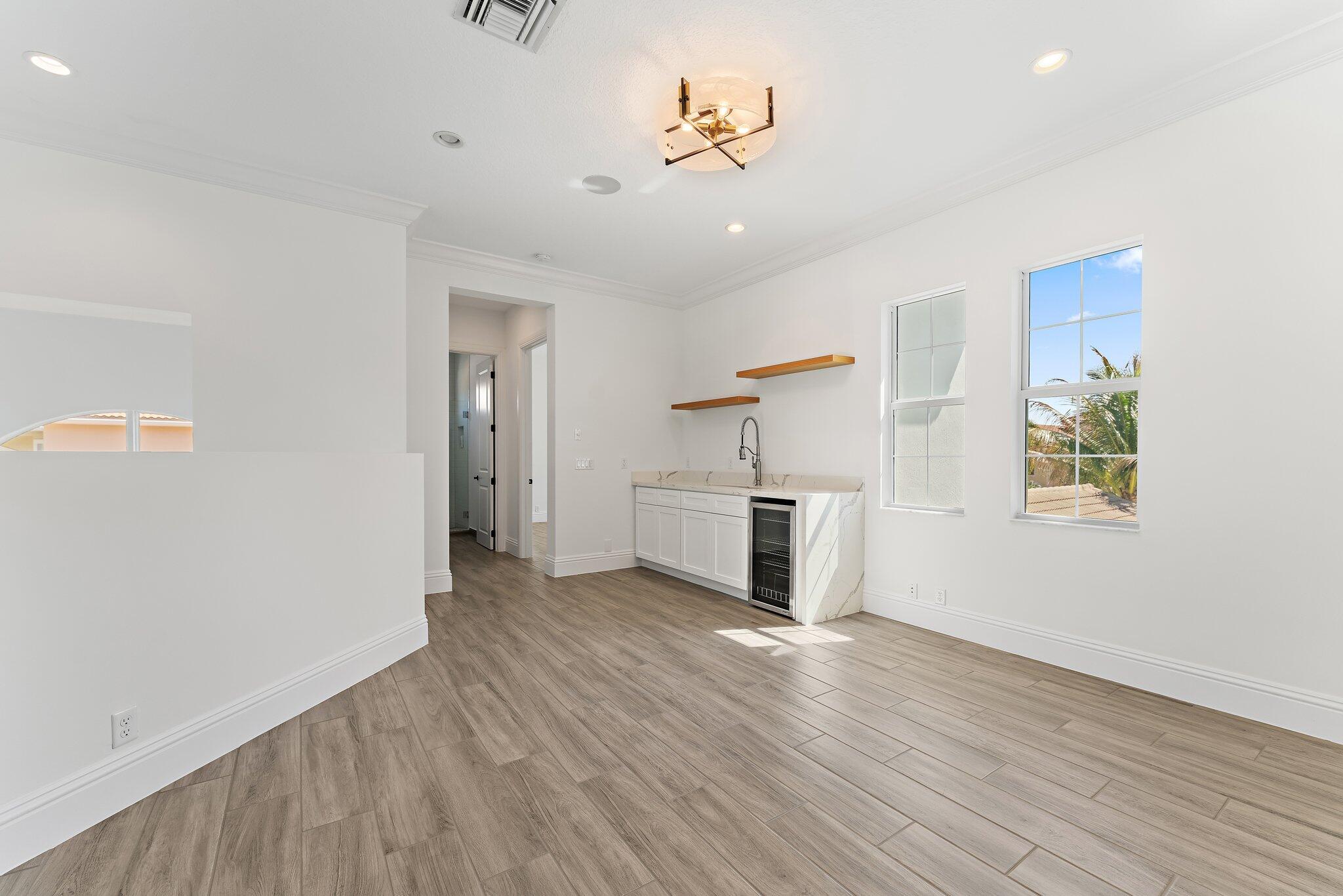 187 Elena Court Jupiter, FL 33478 - Photo 79 of 105 wooden floor in an empty room with a window