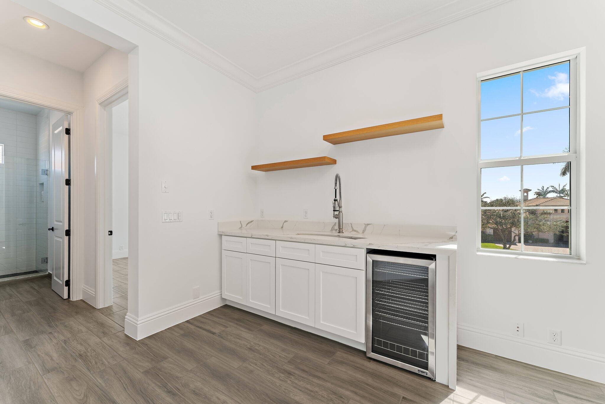 187 Elena Court Jupiter, FL 33478 - Photo 80 of 105 a kitchen with a sink cabinets and wooden floor