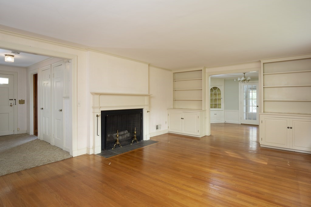 19 Priscilla Road Wellesley, MA 02481 - Photo 3 of 10 a view of an empty room with wooden floor fireplace and a window