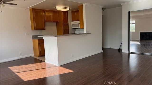 a view of a room with wooden floor