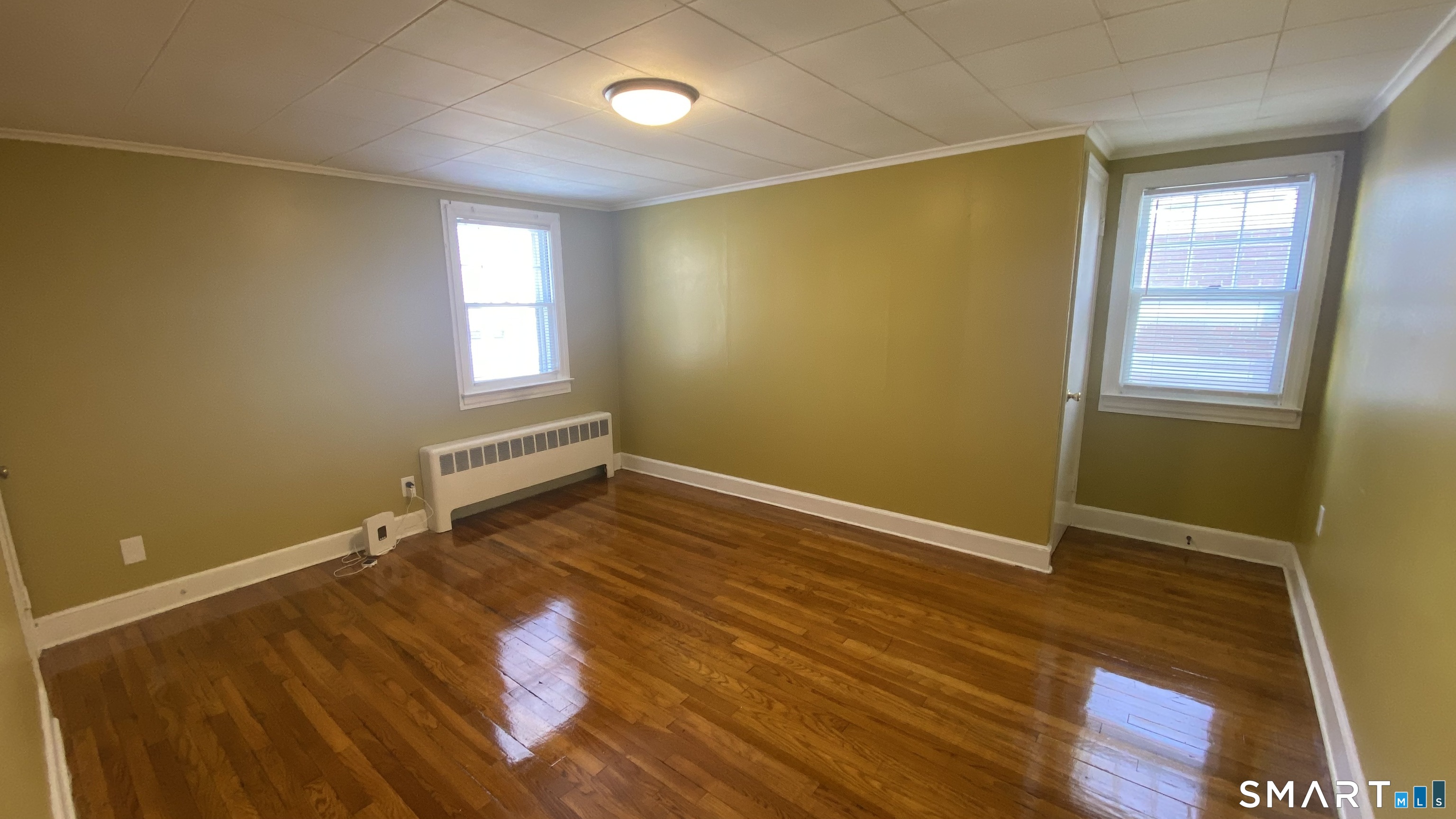 214 Columbia Street, Unit 2 New Britain, CT 06052 - Photo 22 of 31 a view of an empty room with wooden floor and a window