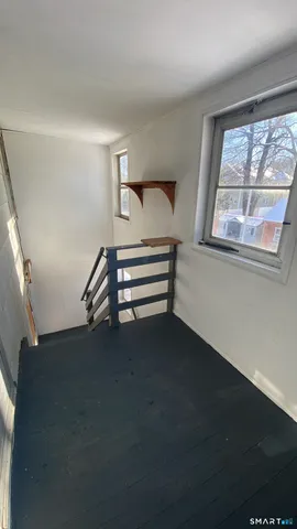 a view of room with window and wooden floor